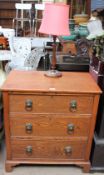 A 20th century oak chest with three long graduated drawers on bracket feet together with a table