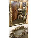 An oval gilt wall mirror together with two other wall mirrors and pictures