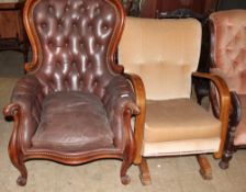 A Victorian mahogany framed spoon back library chair with scrolling arm terminals on scrolling legs