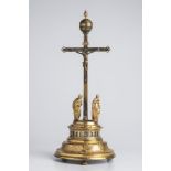 A CRUCIFIXION CLOCK 17th-18th century; Germany 39 cm Gold- and silver-plated brass. Rising from