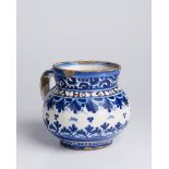 A SMALL PITCHER 10,5 cm Faïence, white glaze, painted in grand feu colors. Small pitcher with a