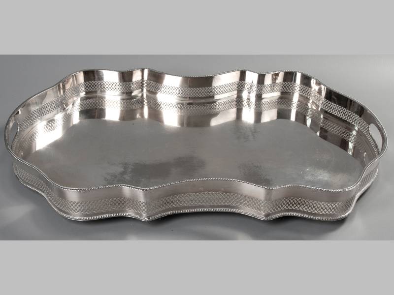 A SILVERPLATED GALLERY TRAY, of rectangular form with serpentine pierced border, gadroon rim,