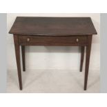 A GEORGE III MAHOGANY WRITING TABLE, the bowed top with a reeded edge above a single long drawer,