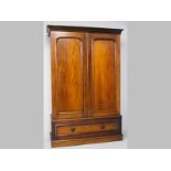 A VICTORIAN MAHOGANY CUPBOARD, the cantered pediment above two arched panel doors, the interior with