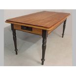 A 19TH CENTURY CAPE STINKWOOD AND YELLOWWOOD DINING TABLE, the three-plank top with a thumb-moulding