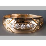 AN 18CT YELLOW GOLD AND DIAMOND RING, five pavé set rose-cut diamonds, on scroll engraved shoulders,