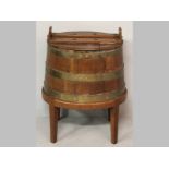 A LATE 19TH CENTURY CAPE TEAK WATERBALIE, the oval lid above a coopered barrel with brass banding on