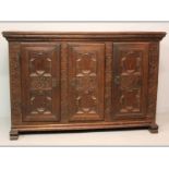 AN 18TH CENTURY DUTCH OAK CABINET, the doubled moulded top above three carved cushioned panelled