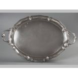 AN .835 STD CONTINENTAL SILVER OVAL TWIN-HANDLED TRAY, scroll handles applied to a reeded border,