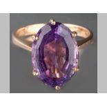 A 9CT YELLOW GOLD AND AMETHYST RING, oval form amethyst claw set on a solid shank, 4.8g.