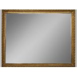 A MASSIVE CLASSICAL STYLE RECTANGULAR MIRROR, the composite frame with carved foliage, blind