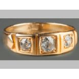 AN 18CT YELLOW GOLD AND DIAMOND RING, three rose-cut diamonds claw set in square forms, decorated