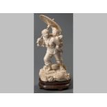 A VERY FINE CHINESE IVORY CARVING OF WOMAN, carrying a child and holding an umbrella, standing on