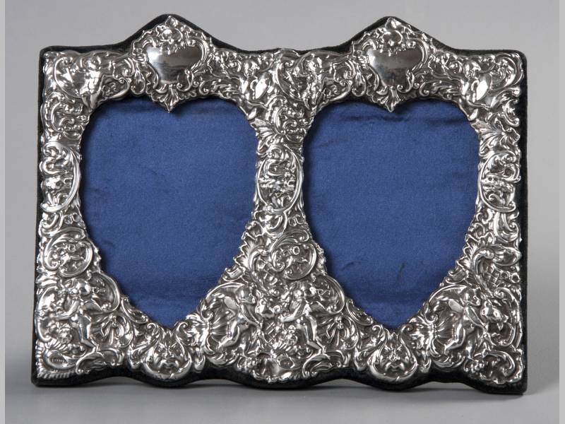 A 20TH CENTURY SILVER DOUBLE HEART SHAPED PHOTOGRAPH FRAME, LONDON 1988, K.F. LTD., the applied