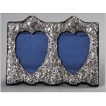 A 20TH CENTURY SILVER DOUBLE HEART SHAPED PHOTOGRAPH FRAME, LONDON 1988, K.F. LTD., the applied
