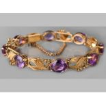 AN 18CT YELLOW GOLD AMETHYST BRACELET, comprising eight oval cut amethysts, interspaced with organic