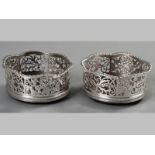 A PAIR OF IRISH SILVER BOTTLE COASTERS, CIRCA 1840, serpentine gadroon rim, alternating cut-out