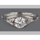 AN 18CT WHITE GOLD AND DIAMOND RING, centre brilliant cut diamond of approximately 0.40cts flanked