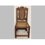 AN 18TH CENTURY CAPE HARDWOOD TULBACH CHAIR, the cane rococo style back above a cane seat,