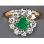 AN 18CT YELLOW GOLD, EMERALD AND DIAMOND RING, centre emerald claw set surrounded by brilliant cut