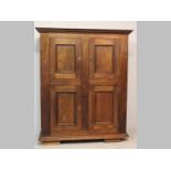 A MID-20TH CENTURY HARDWOOD CUPBOARD, in the 17th-century style, the moulded pediment above four