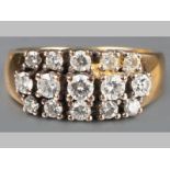 A 14CT YELLOW GOLD AND DIAMOND RING, three rows of five brilliant cut claw set diamonds of