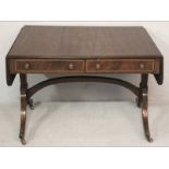 A REGENCY MAHOGANY SOFA TABLE, the reeded top with drop leaves above four short drawers, standing on
