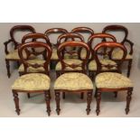 A SET OF TEN VICTORIAN STYLE BUSTLE BACK DINING CHAIRS, including two carvers, the hooped moulded