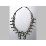 A SILVER AND TURQUOISE NAVAJNO NECKLACE, of organic form.