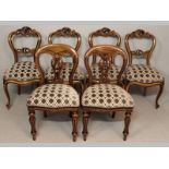 A SET OF FOUR VICTORIAN STYLE DINING CHAIRS, with vigorously carved top-rails and splats with