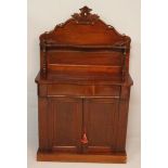 A VICTORIAN MAHOGANY CHIFFONIER, the serpentine top surmounted by a shell, pillars and a crested