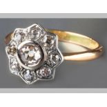 AN 18CT YELLOW GOLD AND DIAMOND RING, centre rose-cut diamond tube set, surrounded by eight rose-cut