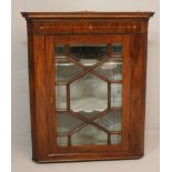 A GEORGE III MAHOGANY CORNER CABINET, the stepped pediment and frieze with boxwood marquetry, the