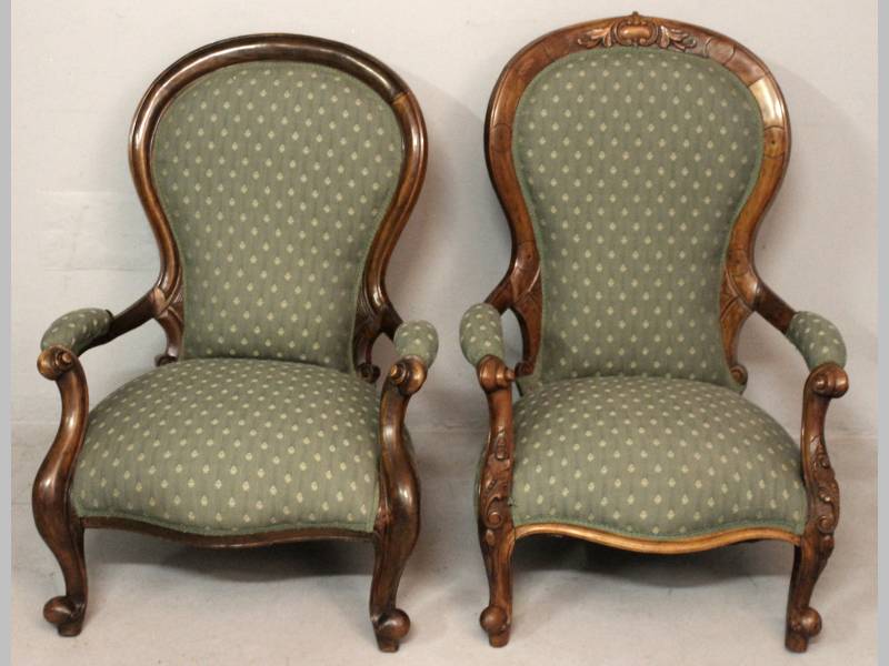 TWO VICTORIAN WALNUT ARMCHAIRS, each with a bowed top-rail above upholstered backs, armrests and