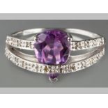 A 9CT WHITE GOLD, DIAMOND AND AMETHYST RING, with central teardrop amethyst, surrounded by two bands