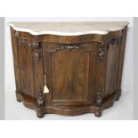 A VICTORIAN ROSEWOOD CABINET, the serpentine marble top above a beaded frieze with rectangular