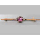 AN 18CT YELLOW GOLD, PINK TOURMALINE AND DIAMOND BAR BROOCH, cushion-cut tourmaline flanked by