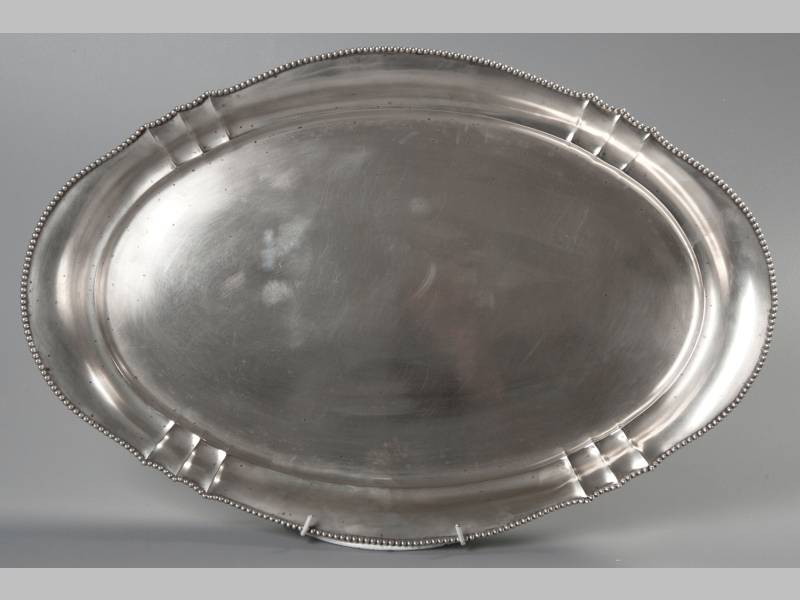 AN .800 STD SILVER TRAY, of oval form, with beaded rim, plain border and well, 51 by 34cm, 1006g.