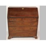 A GEORGE III MAHOGANY FALL-FRONT BUREAU, the fall opening to reveal an interior housing drawers,