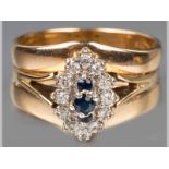 A 9CT YELLOW GOLD, DIAMOND AND SAPPHIRE RING, three central sapphires surrounded by twelve
