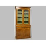 A VICTORIAN MAHOGANY BOOKCASE CABINET, the upper-section with a moulded pediment above two glazed