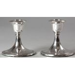 A PAIR OF SILVER CANDLESTICKS, BIRMINGHAM 1958, S.B. & S.D., reeded decoration, on circular bases,