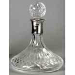 A SILVER COLLARED AND CUTGLASS SHIP'S DECANTER, DUBLIN 1980, A & CO. LTD., 25cm high.