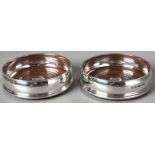 A PAIR OF SILVER BOTTLE COASTERS, LONDON 1972, S.H., reeded banding, fruitwood interior, 3 by 12.