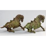 A PAIR OF 20th CENTURY CHINESE BRONZE TANG STYLE HORSES, with green patination, 39cm overall.