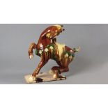 A 20th CENTURY CHINESE MODEL OF A HORSE, in the Tang-style, with brown, yellow and green glaze,
