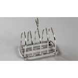 AN EDWARDIAN SILVER TOASTRACK, LONDON 1902, MAKER'S MARK INDECIIPHERABLE, retailed by The