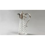 A SILVER AND CUTGLASS CLARET JUG, BIRMINGHAM 1973, C.S.G. & Co., hinged top with C-scroll handle,