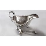 A GEORGE IV SILVER SAUCE BOAT, SHEFFIELD 1919,MAKER'S MARKS INDECIPHERABLE, serpentine rim, with