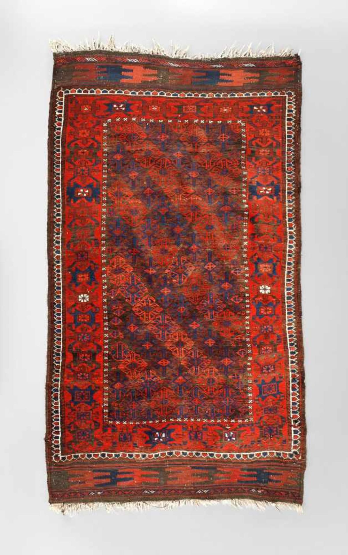 Belutsch Teppich um 1900, rapportierter geometrischer Dekor auf rotem Fond im kräftigen Kolorit, gut